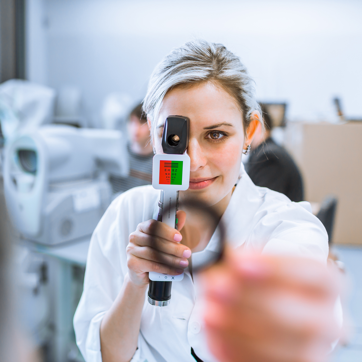 Optometry concept pretty young optometrist at work, examinatin